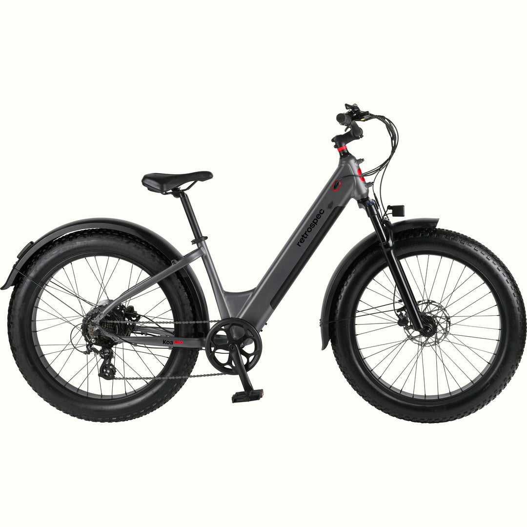 A stylish gray Koa Rev 3 Fat Tire Step-Through Electric Bike with a sleek frame, wide tires, and front suspension, designed for off-road adventures.