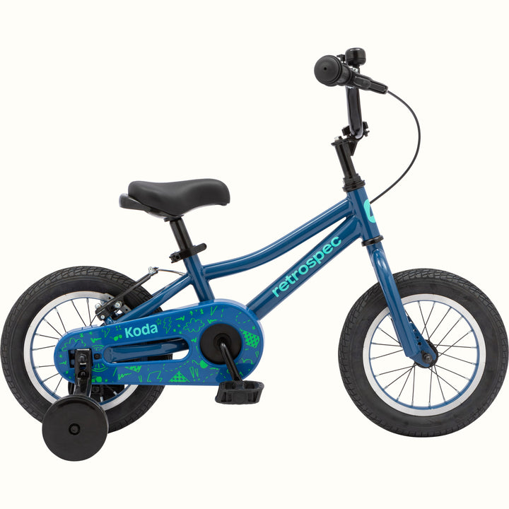 Children's Koda 12" bike with black training wheels and a patterned chain guard.