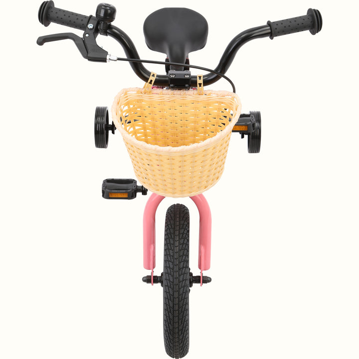 A pink children's bicycle with a beige woven basket and training wheels, viewed from the front.