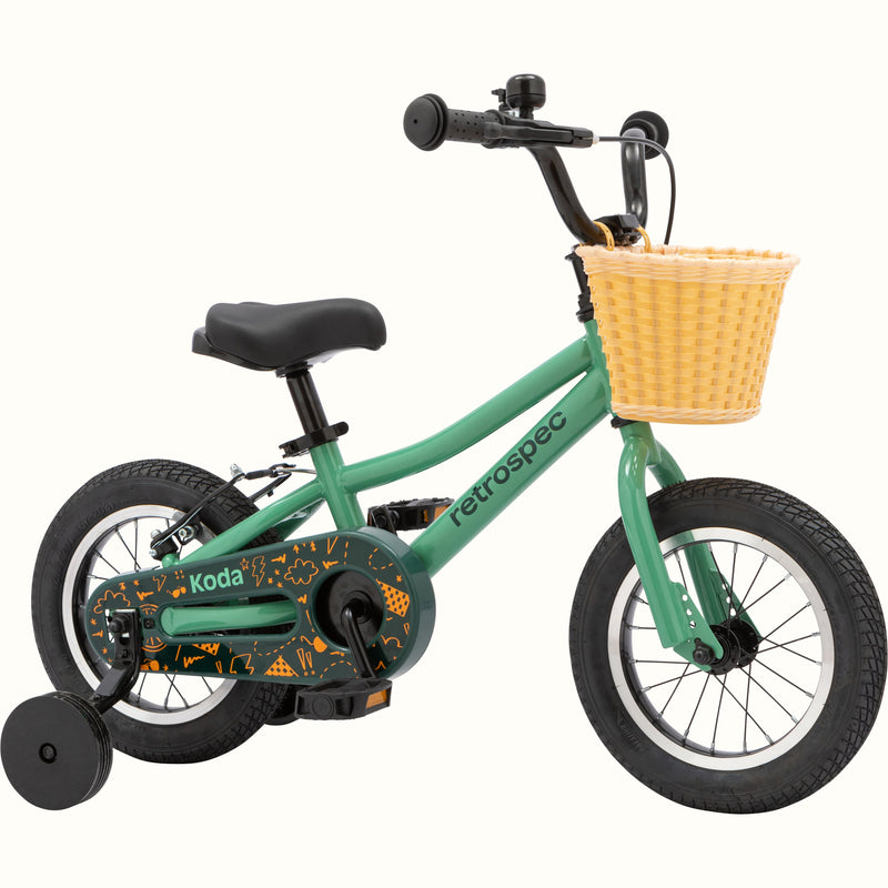 A green children's bike with training wheels and a front basket.