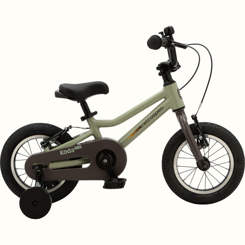 Koda Plus Iguana children's bike with training wheels, green frame, and black details.