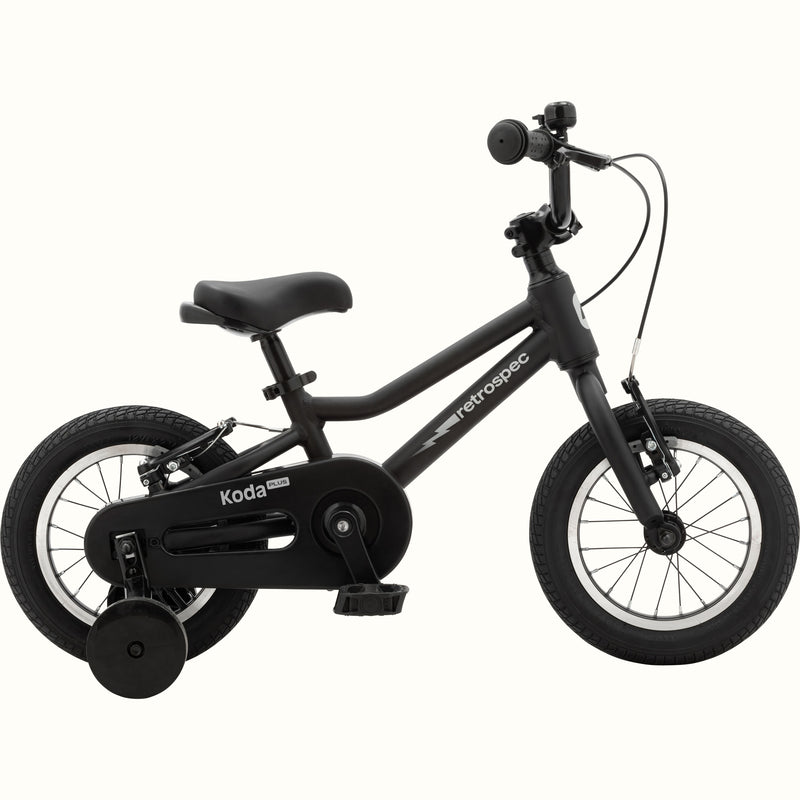 Koda Plus 12 Inch Kids' Bike in Matte Black with training wheels, a lightning bolt on the frame, and a black chainguard.