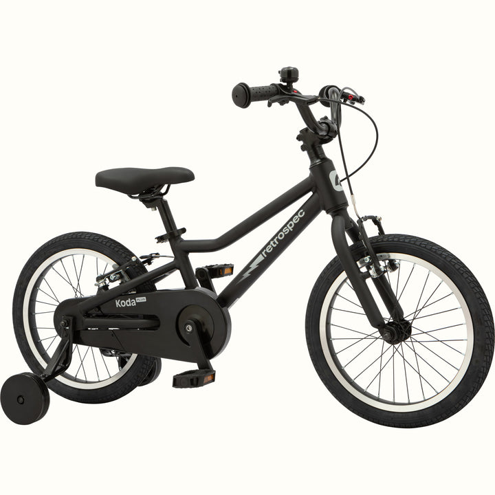 Kids' Koda Plus 16 Inch matte black bike with training wheels isolated on a white background.