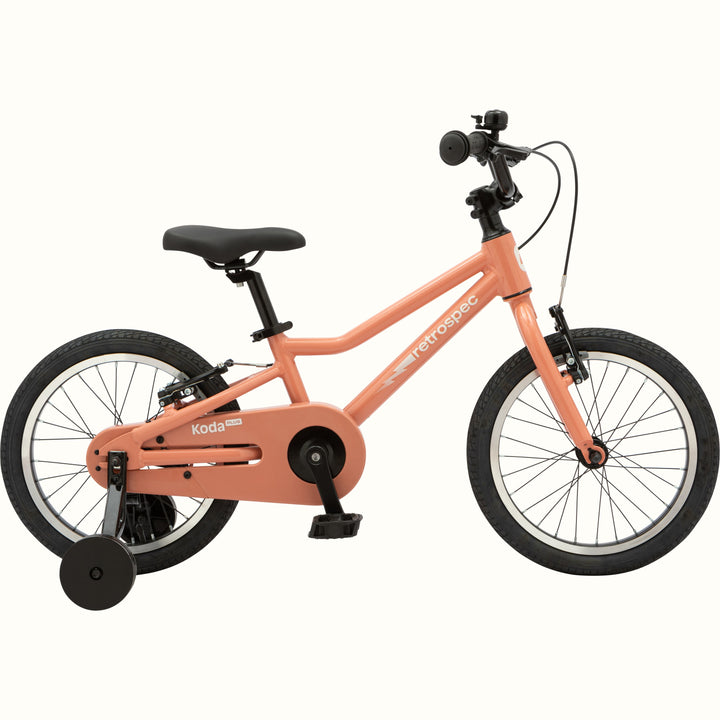 Kids' Koda Plus 16 Inch rose pink bike with training wheels isolated on a white background.