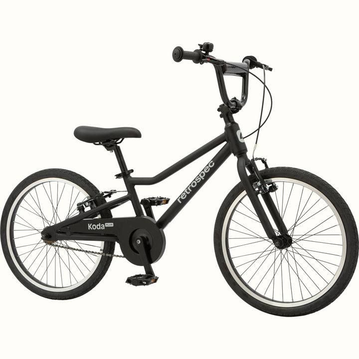 Matte black kids' Koda Plus 20" Bike with black chain guard and black saddle on a white background.
