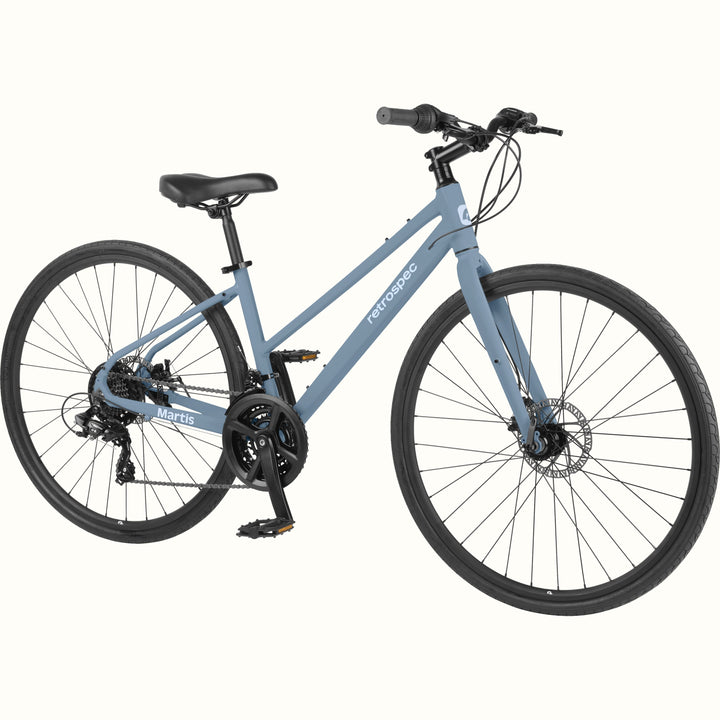 retrospec Martis commuter bike in Matte Fog, angled to show the triple chainring, rear drivetrain, and front disc brake.