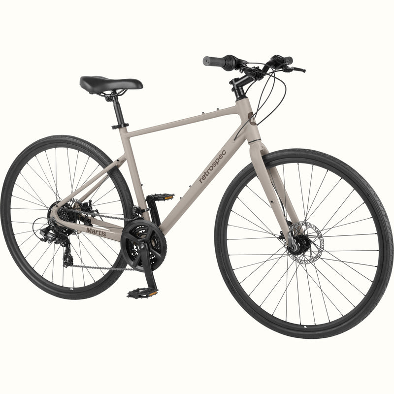 retrospec Martis hybrid bike in Matte Boulder, angled view showing front disc brake, flat pedals, and wide saddle.