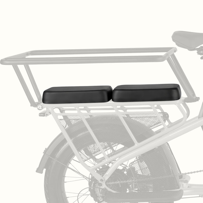 Roo Rev XL Cargo Electric Bike rear rack passenger seat cushion, black two-piece bench pad shown at an angle with a handrail installed.