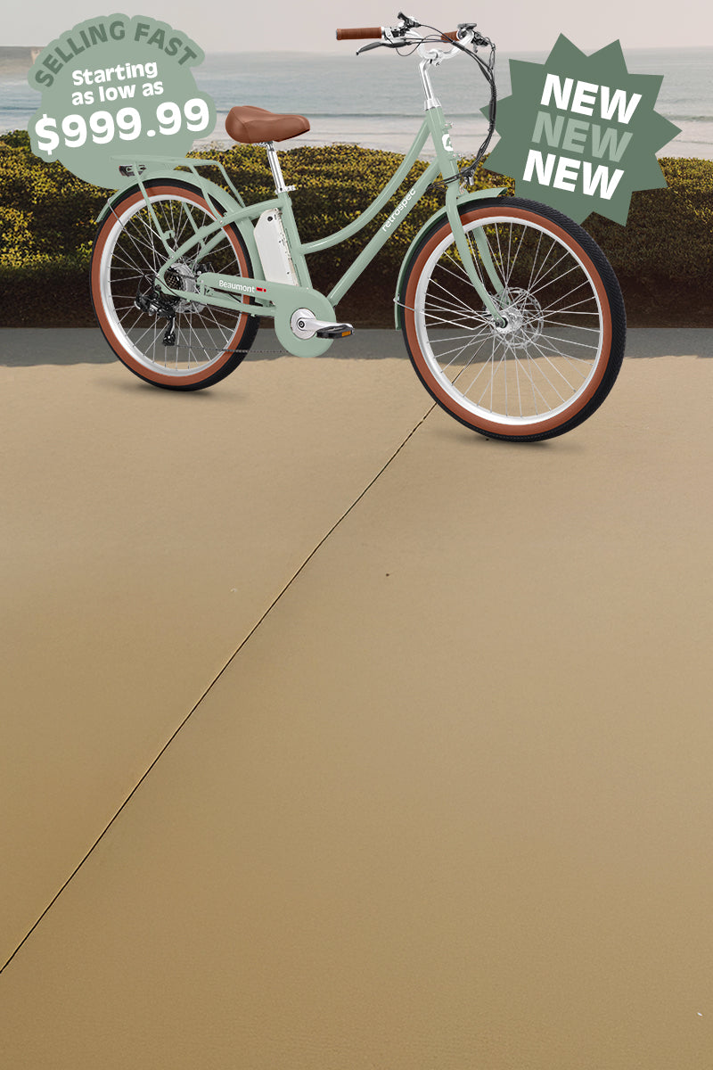 Mint green electric bicycle on a path by the ocean, with a sign indicating a price of $999.99 and notes it is selling fast.