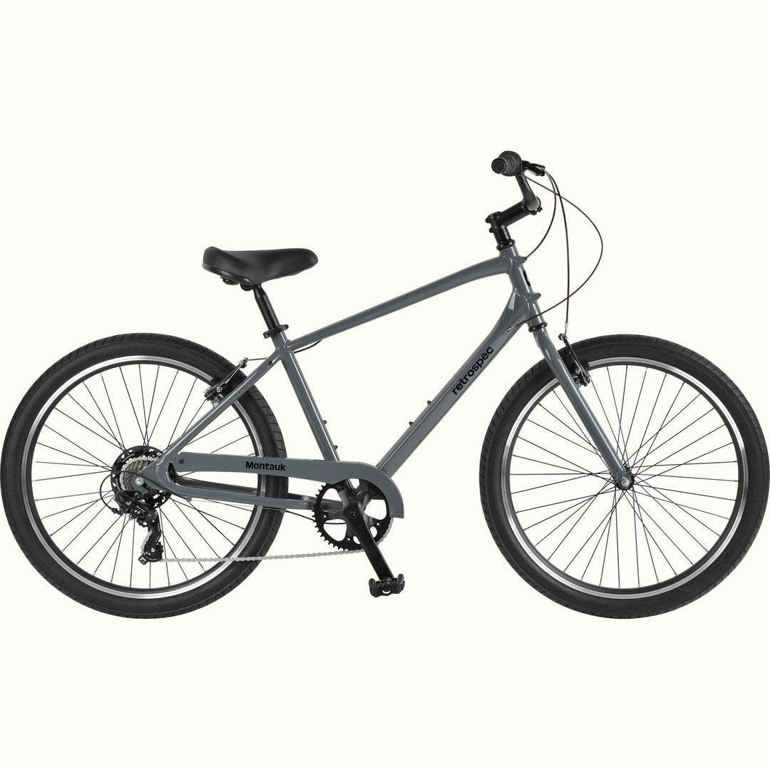 retrospec Montauk 26-inch 7-speed cruiser bike in graphite gray with black tires, saddle, and upright handlebars, shown on a clean white background.