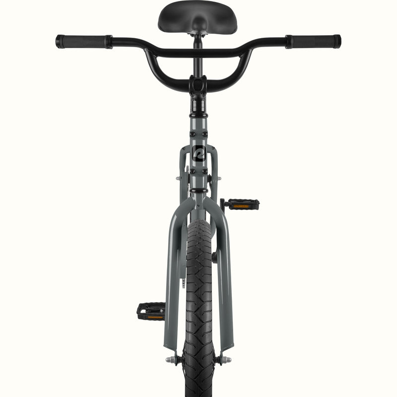 Front view of the retrospec Montauk cruiser bike in graphite, highlighting the wide black handlebars, black saddle, graphite fork, and treaded front tire.