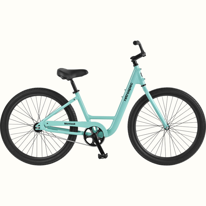 retrospec Montauk cruiser bike in seafoam with a low step-through frame, black tires, saddle, and upright handlebars, shown on a clean white background.