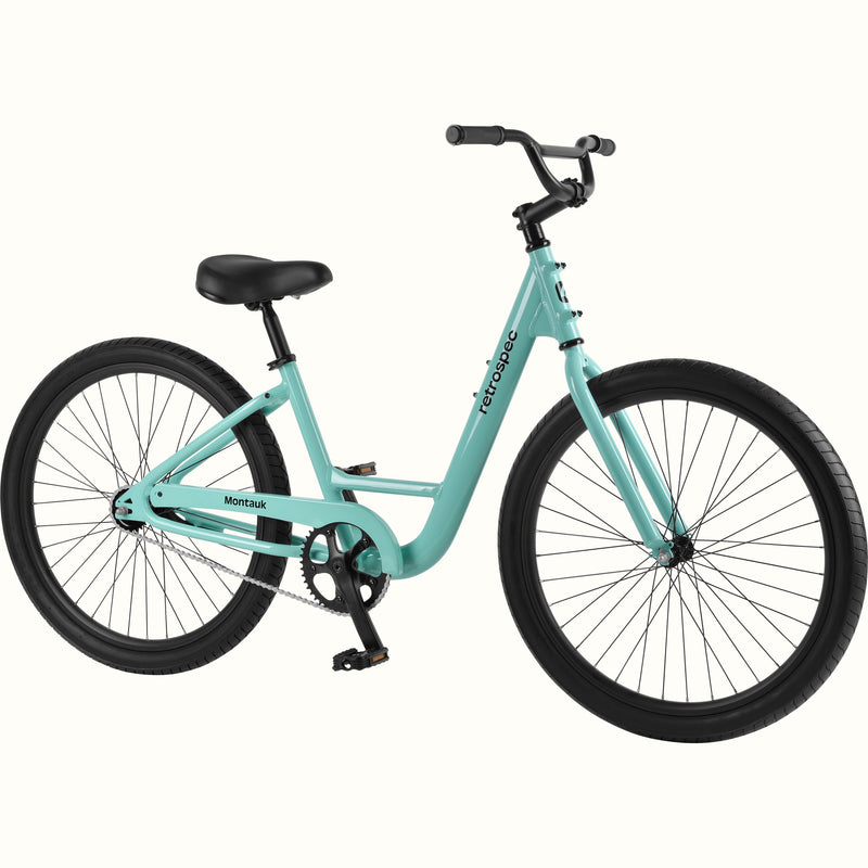 retrospec Montauk cruiser bike in seafoam with a low step-through frame, black tires, saddle, and upright handlebars, shown on a clean white background.