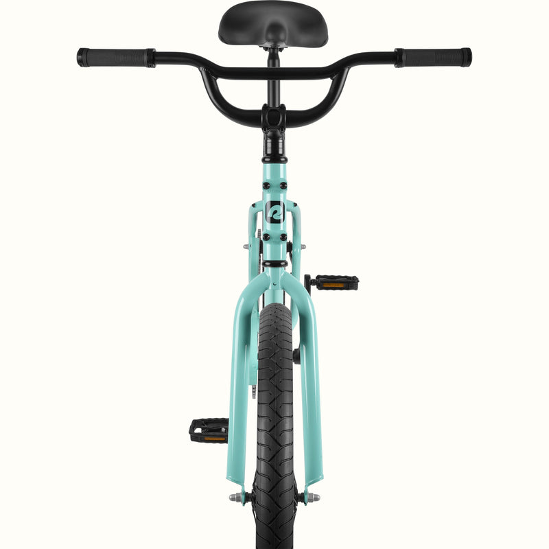 Front view of the retrospec Montauk cruiser bike in seafoam, highlighting the wide black handlebars, black saddle, seafoam fork, and treaded front tire.