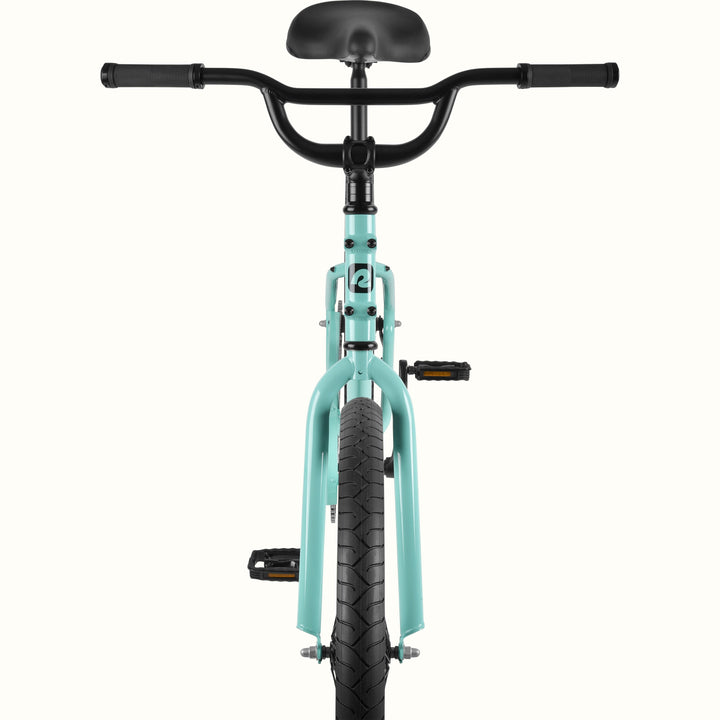 Front view of the retrospec Montauk cruiser bike in seafoam, highlighting the wide black handlebars, black saddle, seafoam fork, and treaded front tire.