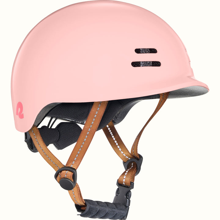 Pink toddler bike helmet with a brown strap on a white background.