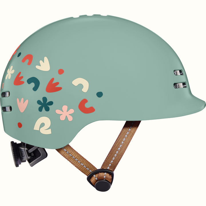 Light green toddler bike helmet with colorful graphics and a brown strap on a white background.