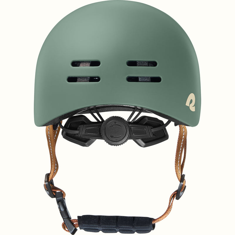 Green toddler bike helmet with a brown strap on a white background.
