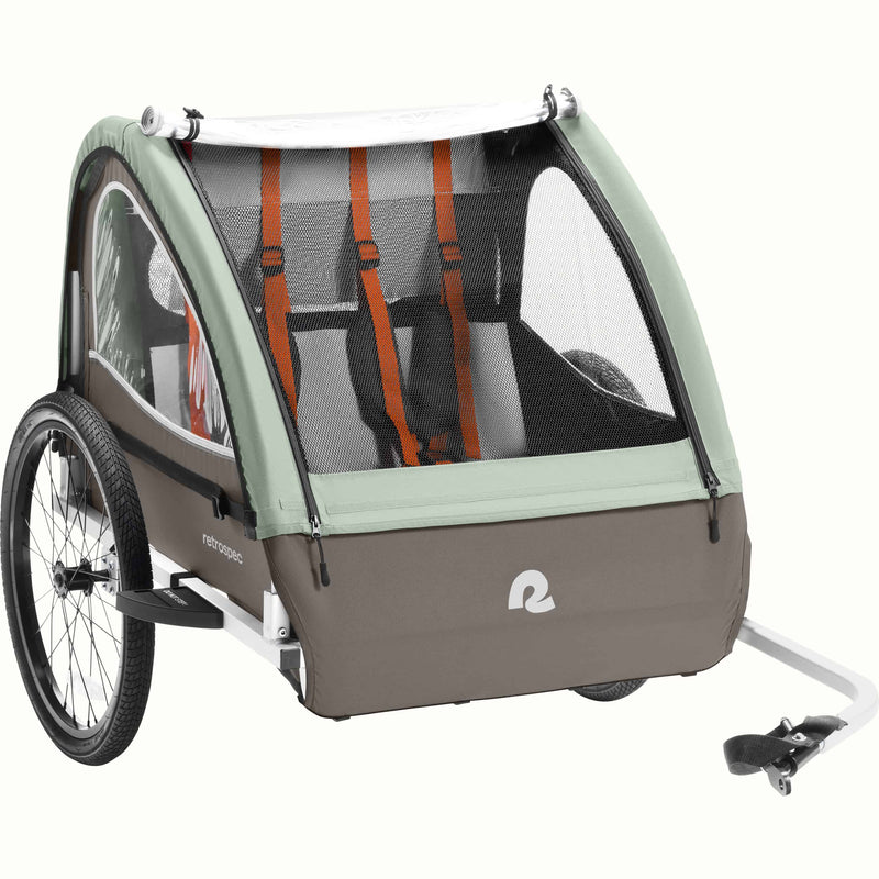 A Rover Plus Child Double bike trailer with a mesh front, featuring orange harness straps and a sturdy frame, designed for safety and comfort.