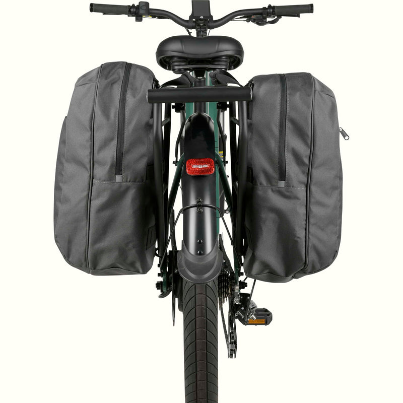 Rear view of a green ebike with mounted pannier saddle bags on the rack.