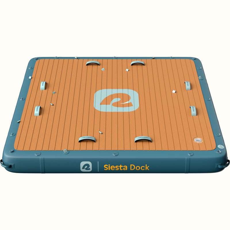 A floating water mat labeled "Siesta Dock" with a non-slip surface and blue edges.