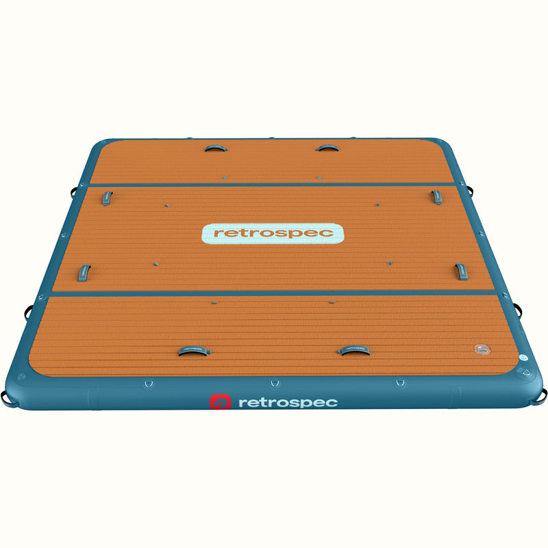 The Siesta Dock XL Inflatable Platform in Atlantic Blue with a wood grain design on the deck, including top and side handles.