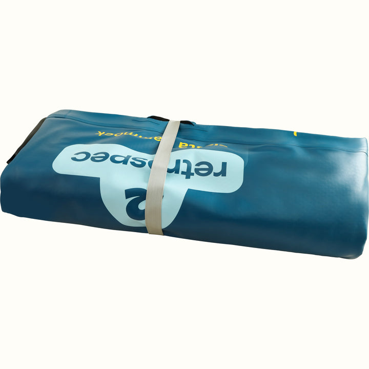 A deflated Siesta Inflatable Hammock 8' Circle rolled up and secured with a gray strap.