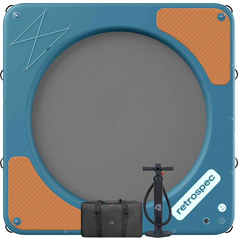 Top view of the Siesta Hammock XL Inflatable Water Platform 10' showing a blue deck with wood panel texture accents and bungee storage area, with a circle mesh center and carry bag with floor pump.