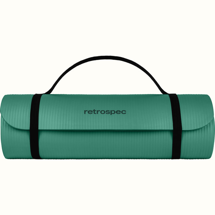 Green Solana 1" Yoga Mat rolled up and secured with a black strap on a white background.