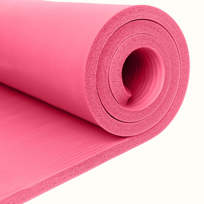 Close-up of pink Solana 1" Yoga Mat  rolled up on a white background.