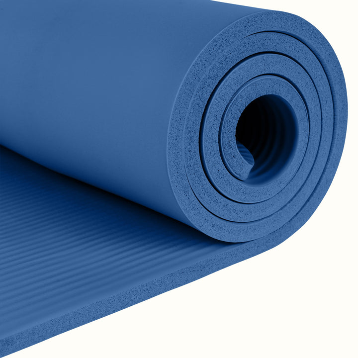 Close-up of the blue Solana .5" Yoga Mat rolled up on a white background.