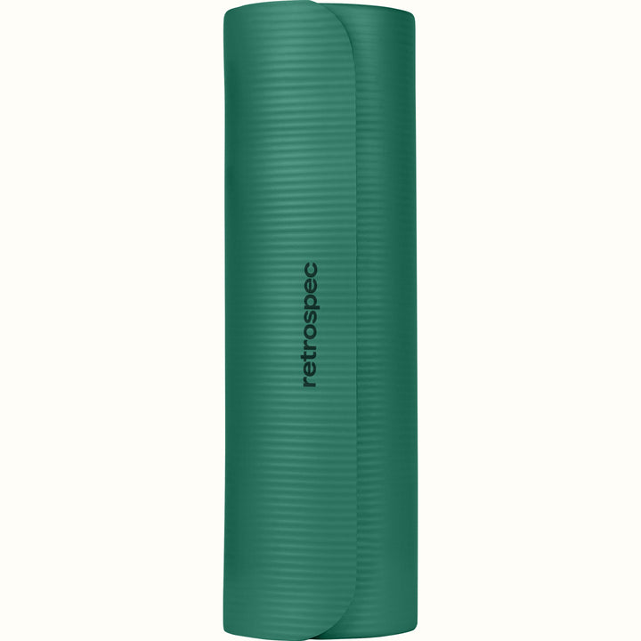 Green Solana .5" Yoga Mat rolled up with 'retrospec' branding on a white background.