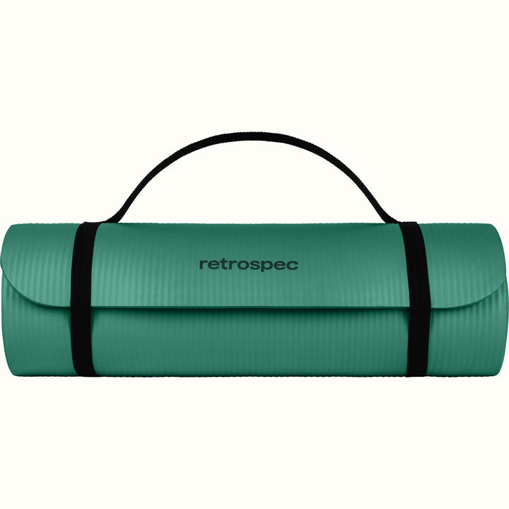 Green Solana .5" Yoga Mat rolled up and secured with a black strap on a white background.
