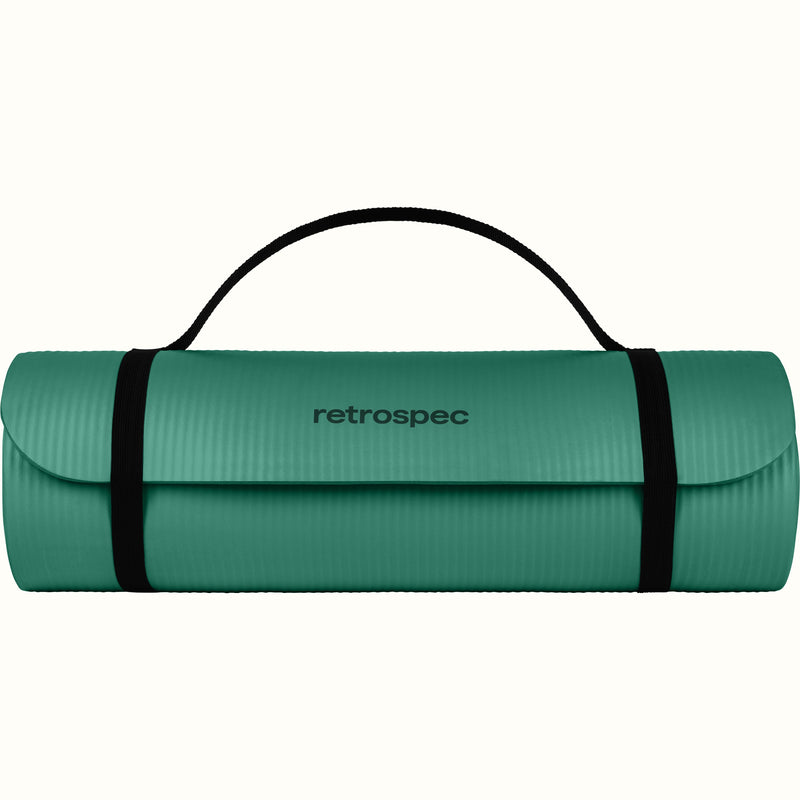 Green Solana .5" Yoga Mat rolled up and secured with a black strap on a white background.