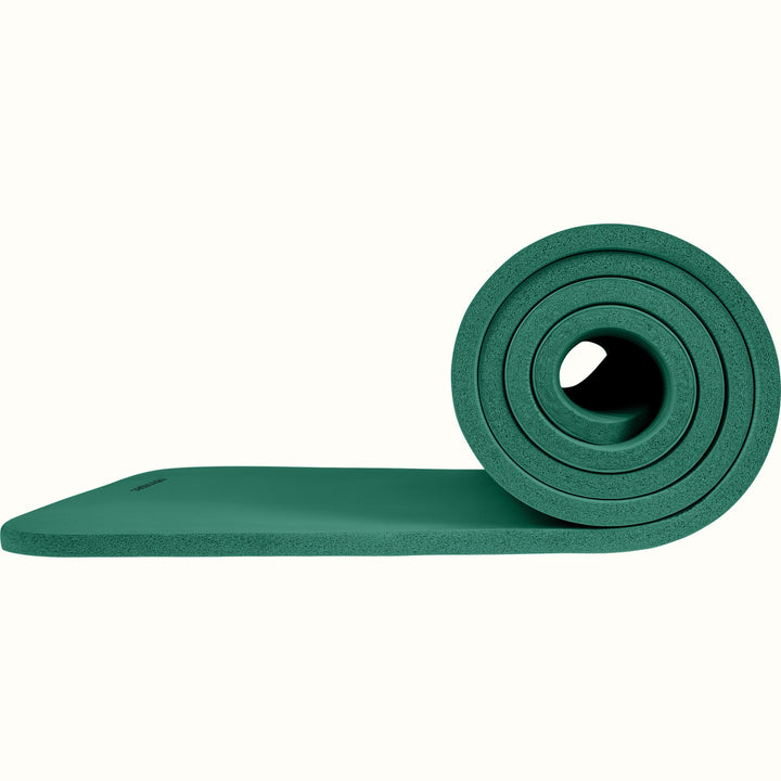 Green Solana .5" Yoga Mat rolled up on a white background.