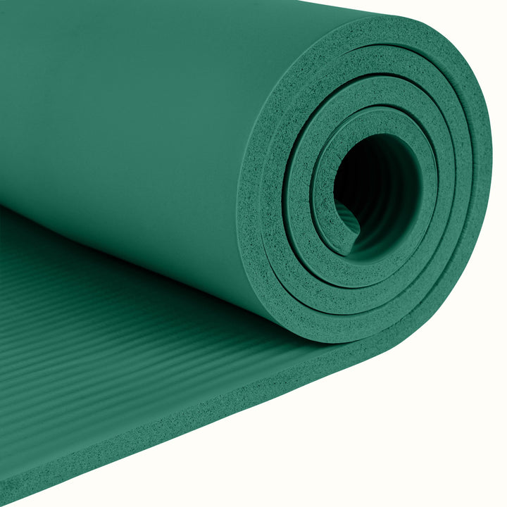 Close-up of the green Solana .5" Yoga Mat rolled up on a white background.