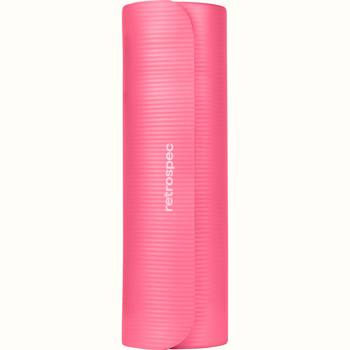 Rolled up pink Solana .5" Yoga Mat with 'retrospec' branding on a white background.