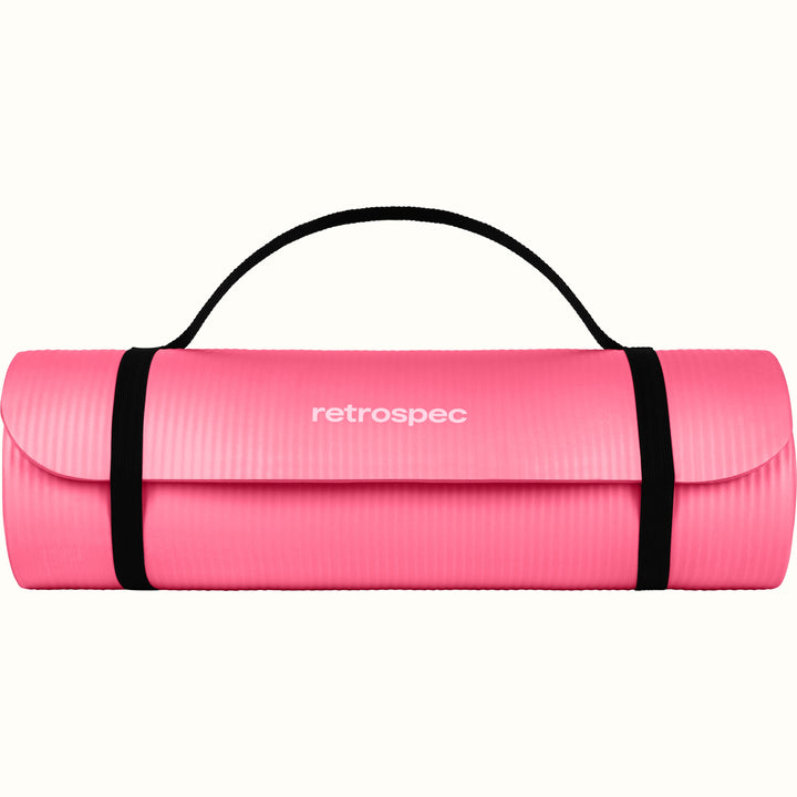 Pink Solana .5" Yoga Mat rolled up and secured with black straps and 'retrospec' branding on a white background.