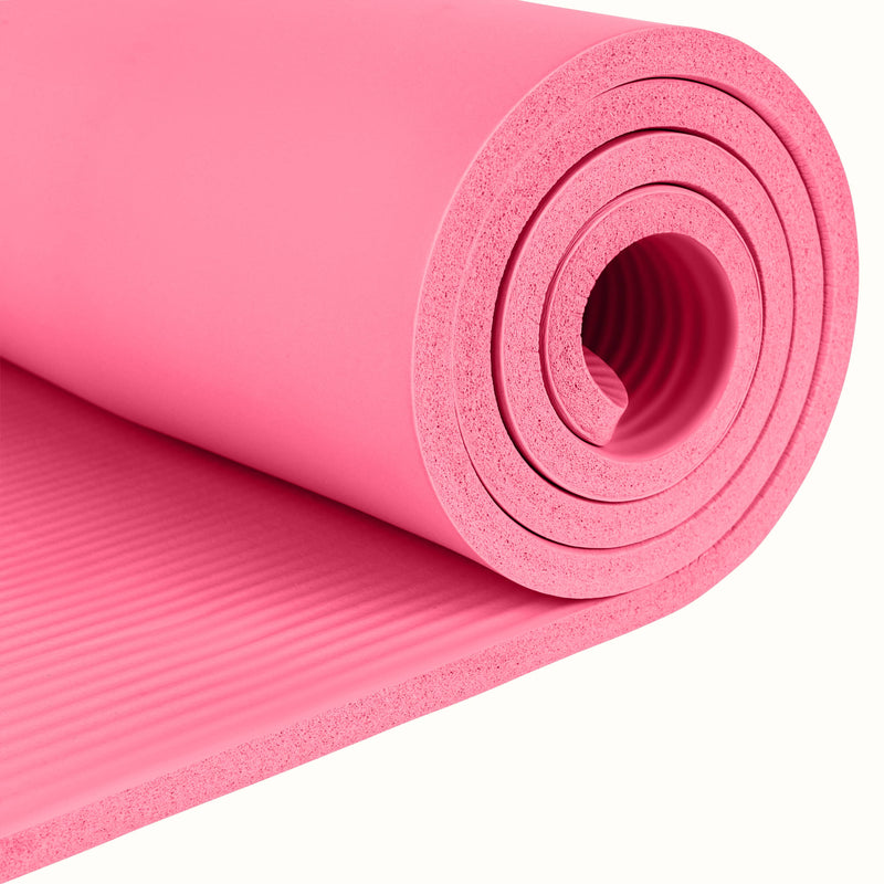 Close-up of the pink Solana .5" Yoga Mat rolled up on a white background.