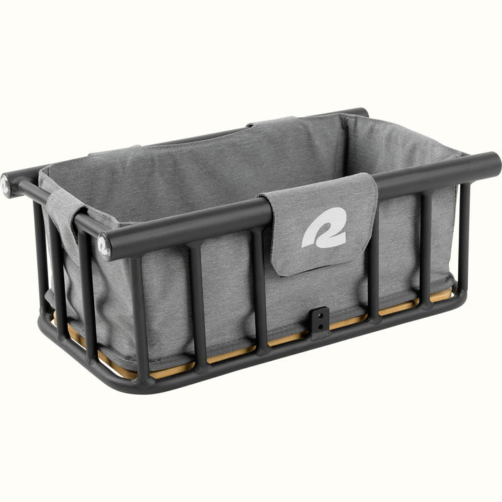 Gray frabric basket liner inside of a metal ebike basket with a "r" on the front.