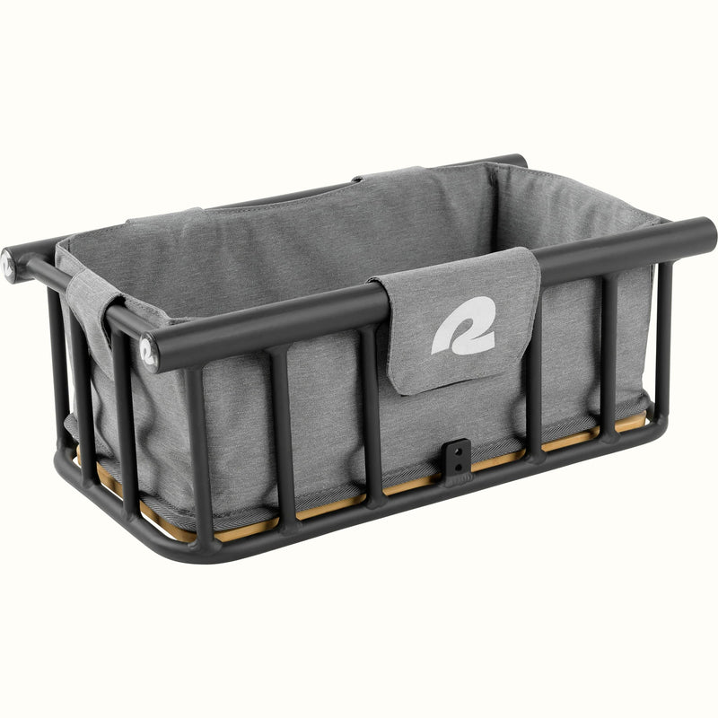 Gray frabric basket liner inside of a metal ebike basket with a "r" on the front.