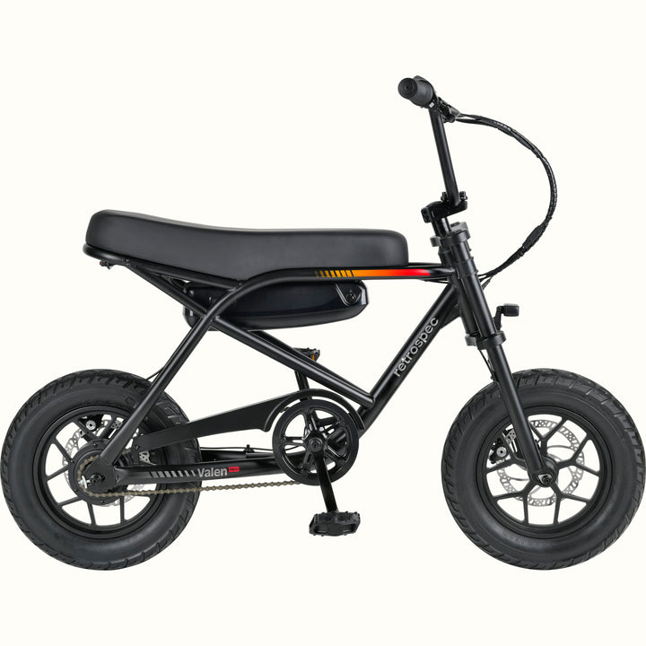 A compact electric mini bike with a black frame, black seat, black tires, and black handlebars, shown from a side profile on a solid white background. The brand names 'retrospec' and 'Valen Rev' are visible on the frame.