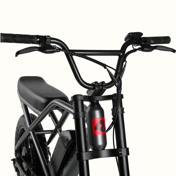 Close0up of the Matte Graphite Valen Rev 3 Fat Tire Electric Bike with black seat on a white background.