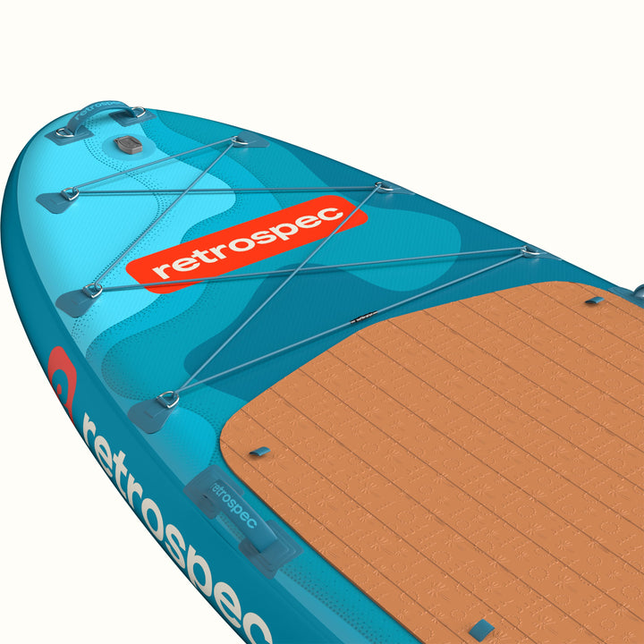 The nose of the Weekender Crew Multi-Person Inflatable Stand Up Paddle Board 12’ in blue with red accents and a brown deck pad.