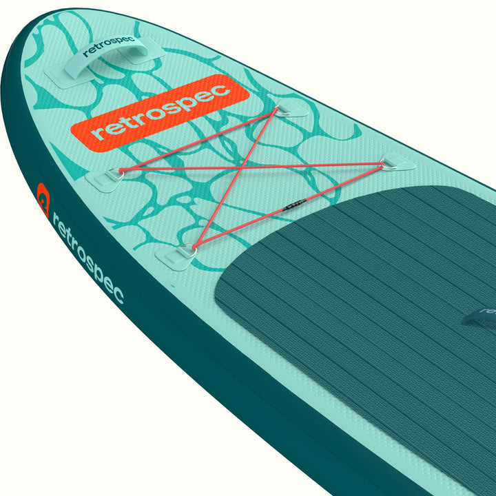 Close-up of the Weekender Nano Kids Inflatable Paddle Board's nose with retrospec logo and ripple design with four point bungee for storage.