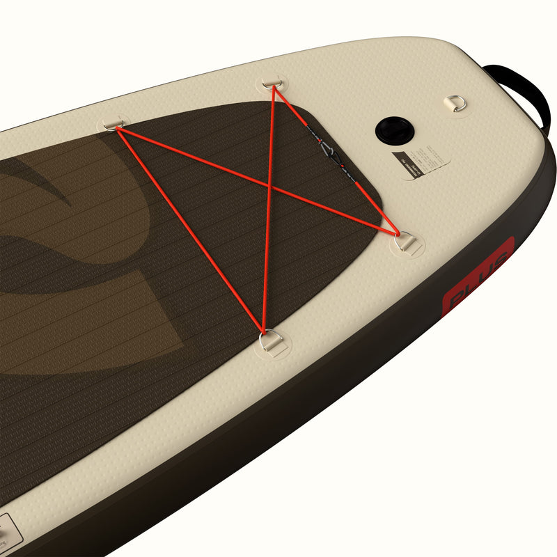 Close-up of the tail of the retrospec Weekender Plus Inflatable Stand Up Paddle Board Kayak Hybrid 10'6" in Bonsai Camo, showing the bungee cargo lacing, D-rings, inflation valve, carry handle, and the red "PLUS" badge on the brown rail.