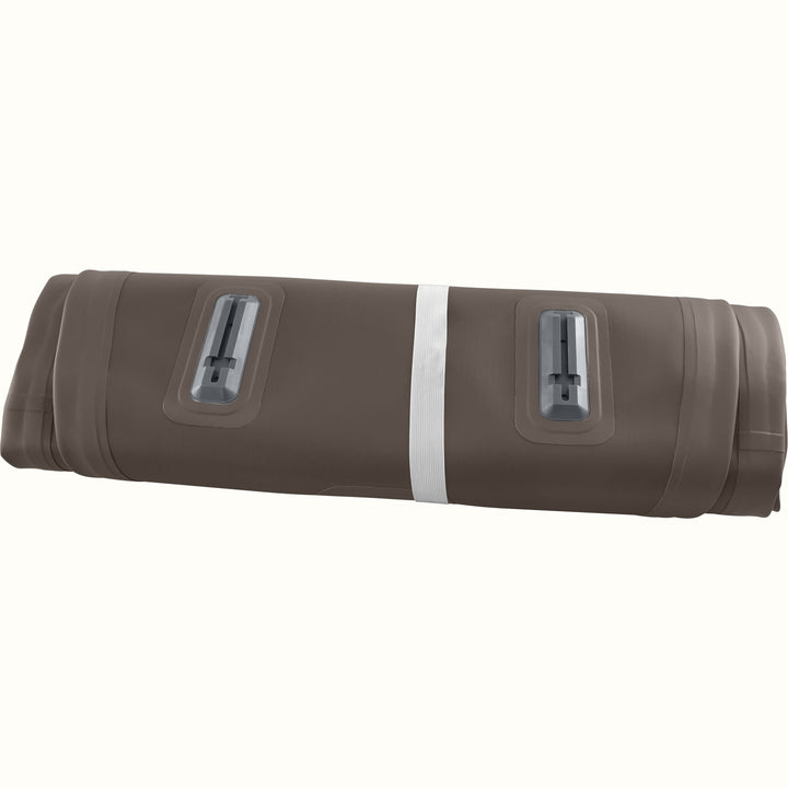 The Weekender XL Inflatable Paddle Board deflated and rolled up, secured with a grey band.