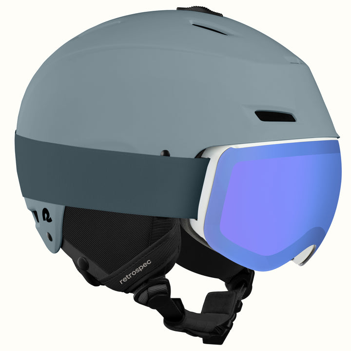 The retrospec Zephyr ski helmet with goggles attached, in Matte Arctic Dusk with a blue mirrored lens.