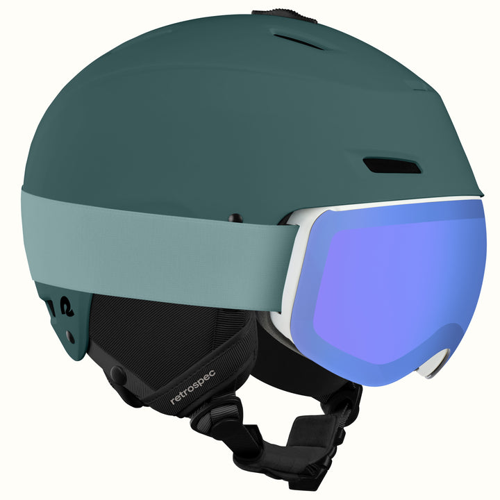 The retrospec Zephyr ski helmet with goggles attached, in Matte Deep Glacier with a blue mirrored lens.