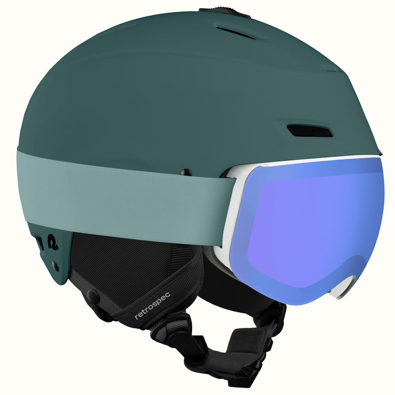 The retrospec Zephyr ski helmet with goggles attached, in Matte Deep Glacier with a blue mirrored lens.